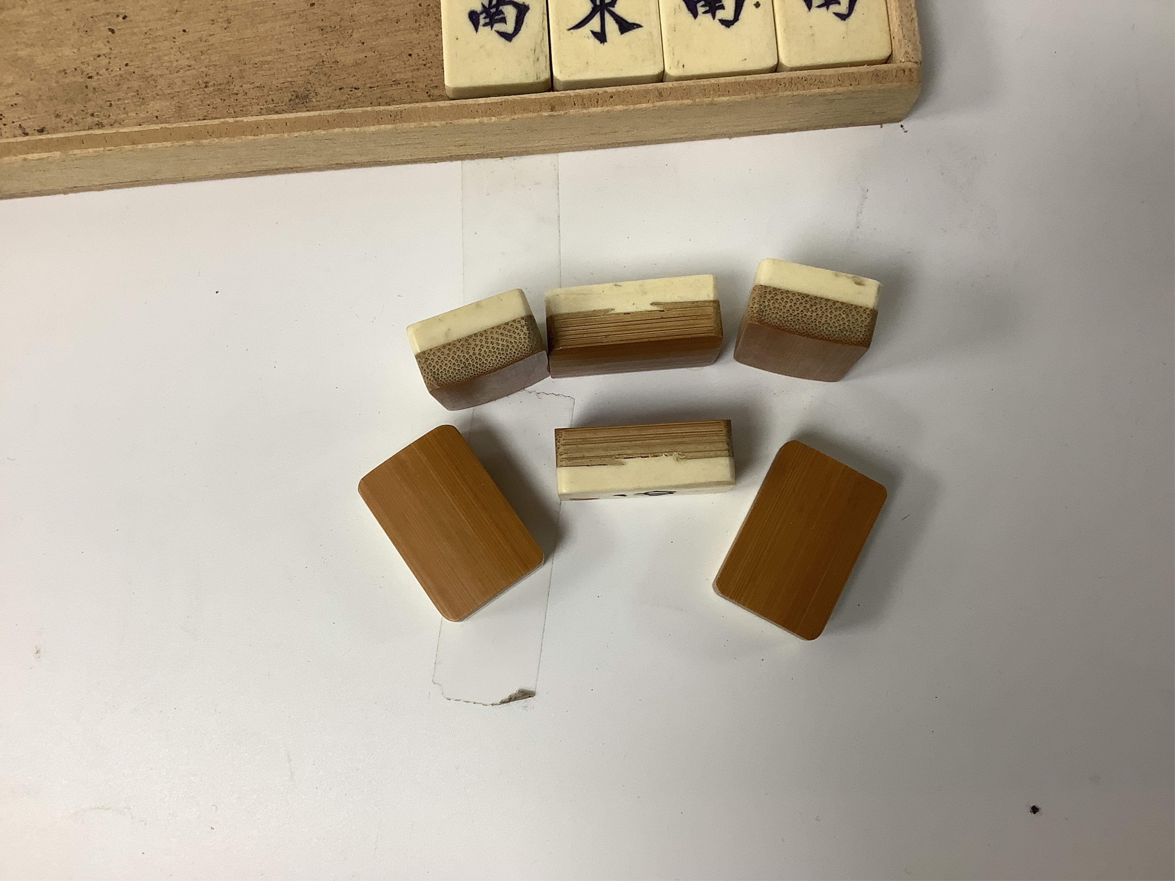 A Chinese bone mahjong set, cased, 23cm wide. Condition - fair